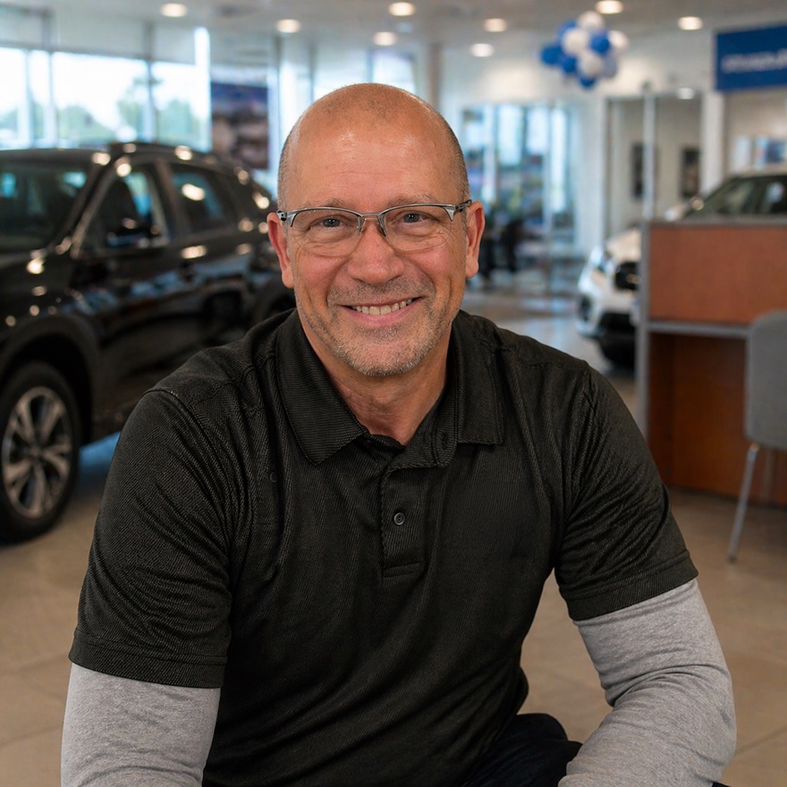 John Fairchild in a dealership showroom